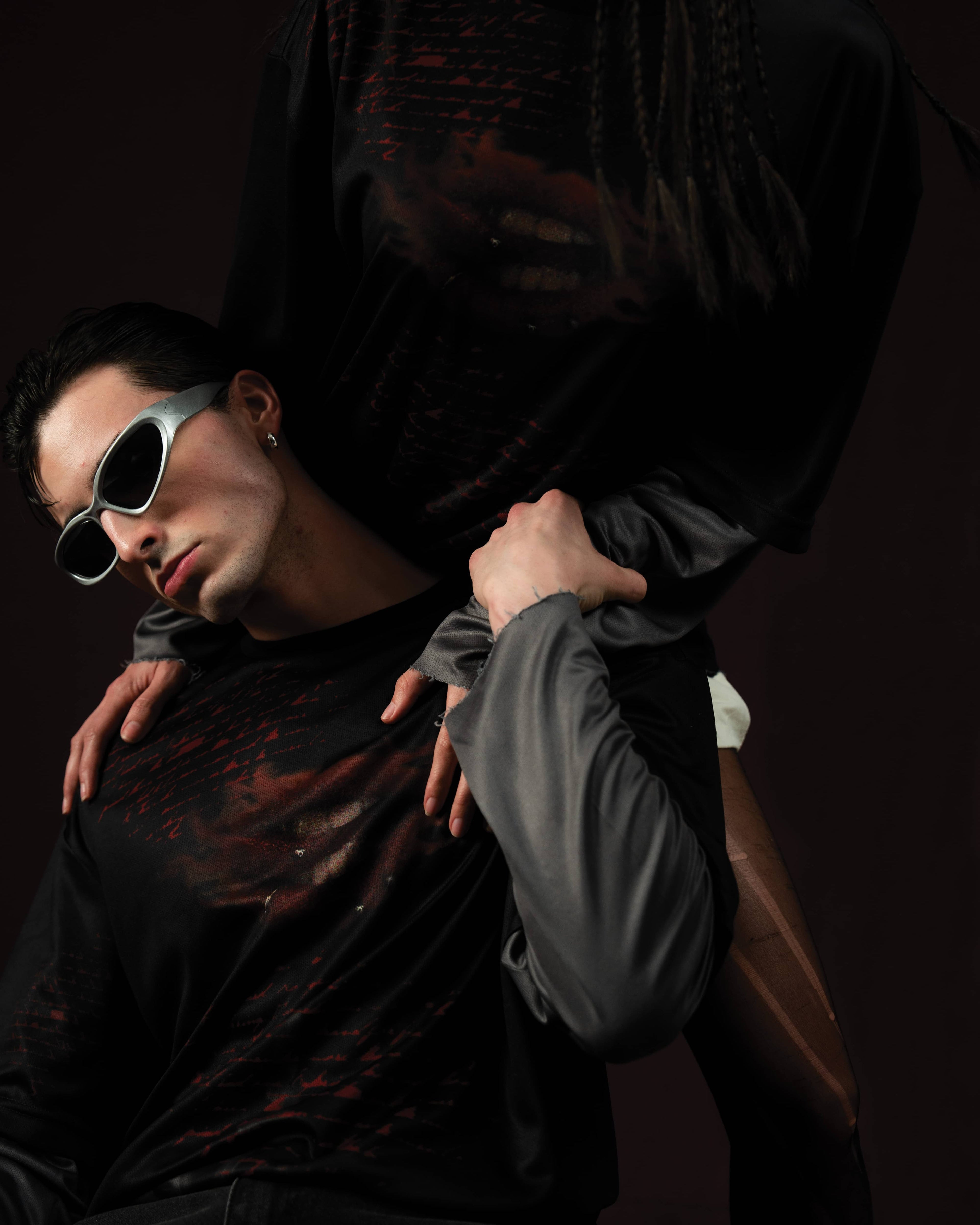 Zica Bella Bloodzic Jersey 01 black oversized streetwear jersey with red graphic styled on male and female models in editorial interaction pose