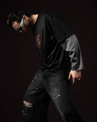 Zica Bella Bloodzic Jersey 01 black oversized streetwear jersey with red graphic worn by male model in dynamic lifestyle pose