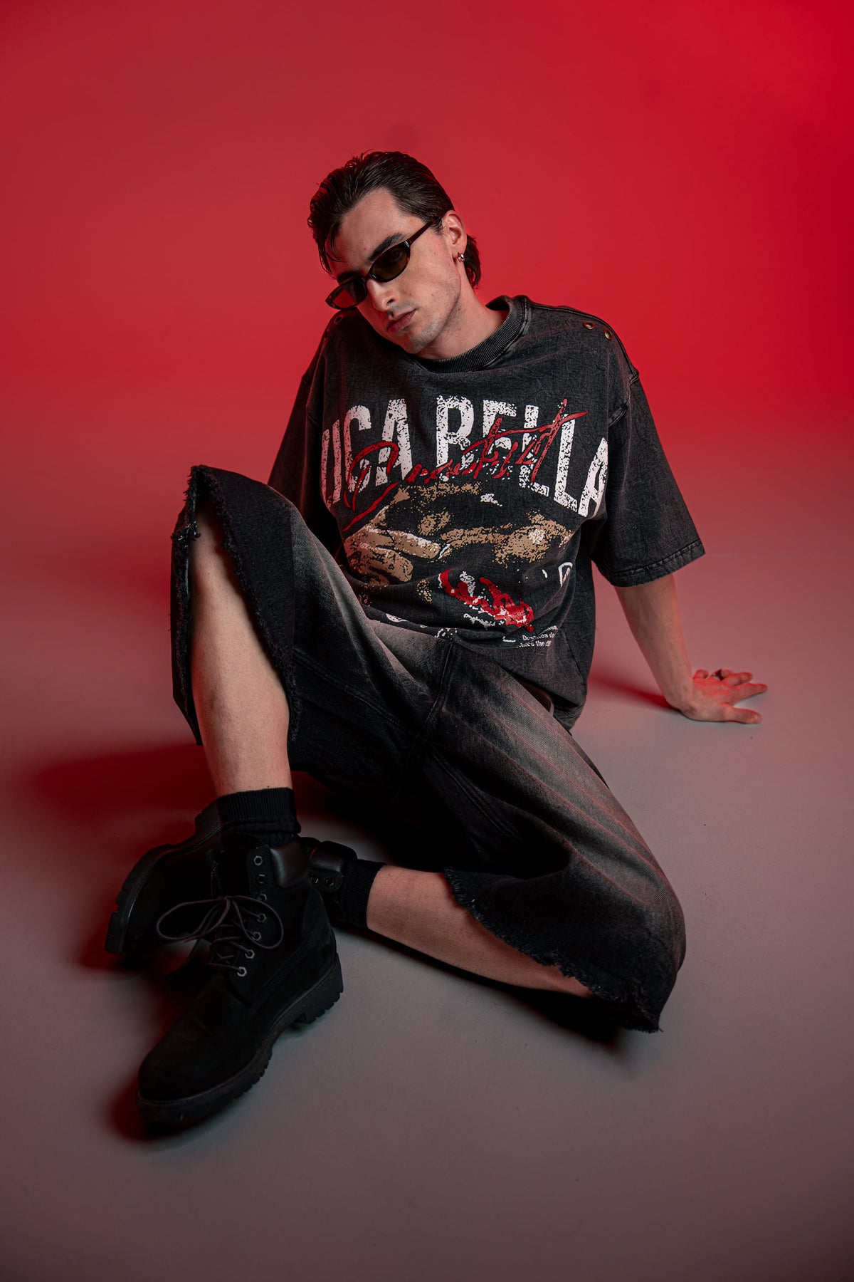 Full outfit shot of oversized graphic t-shirt styled with wide leg streetwear bottoms