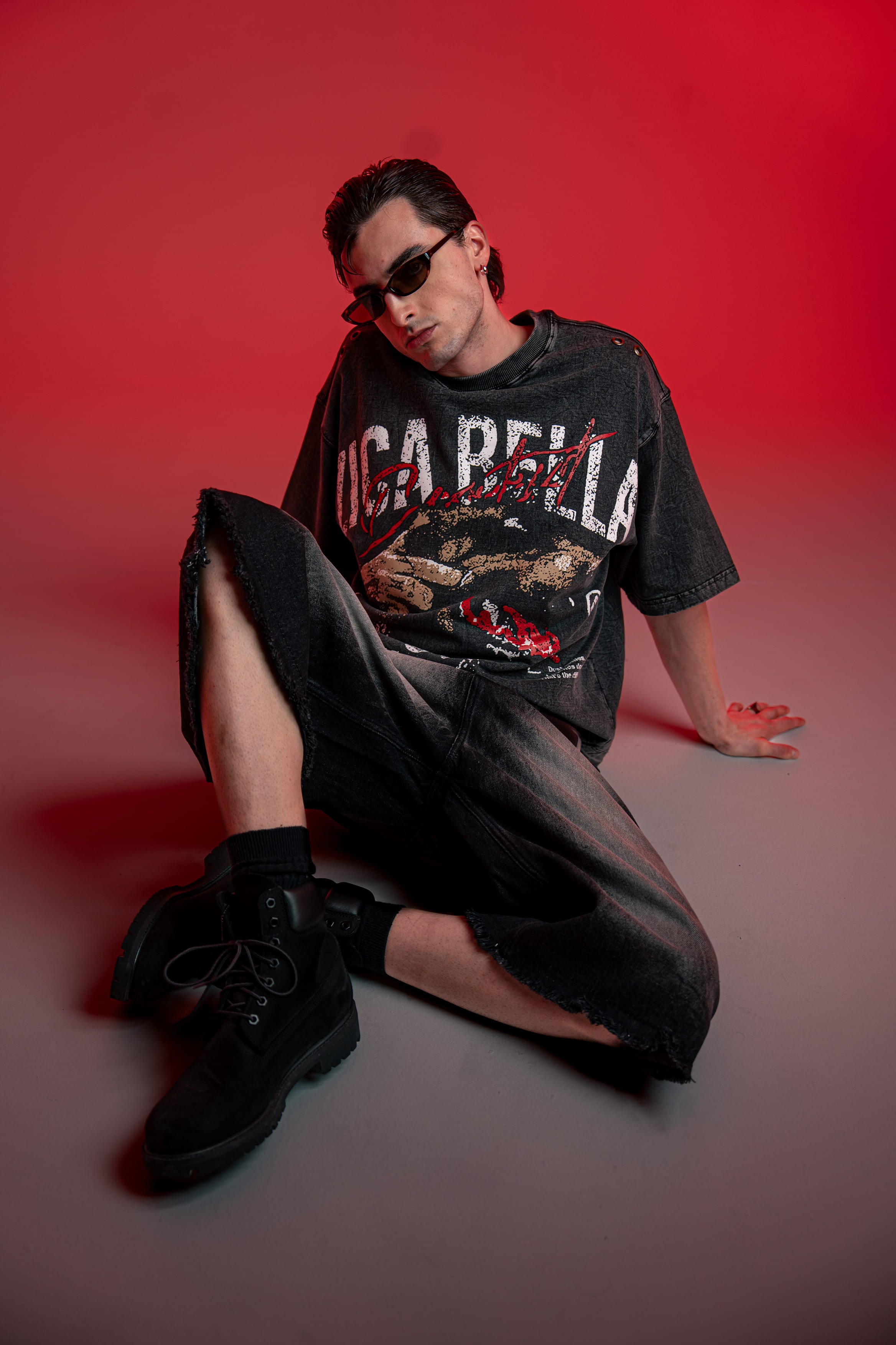 Full outfit shot of oversized graphic t-shirt styled with wide leg streetwear bottoms