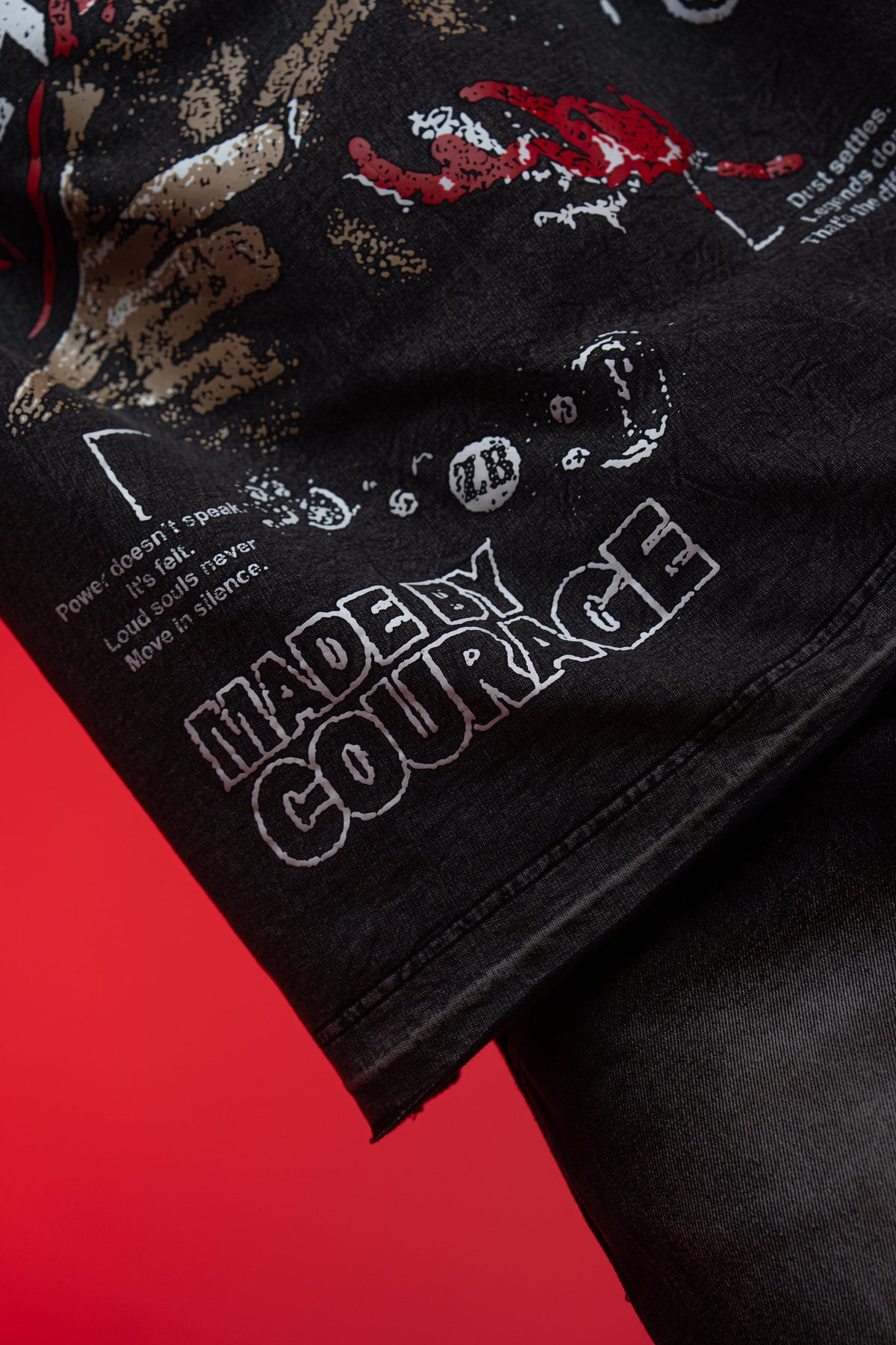 Premium screen print texture and detailed fabric close up of black acid wash t-shirt