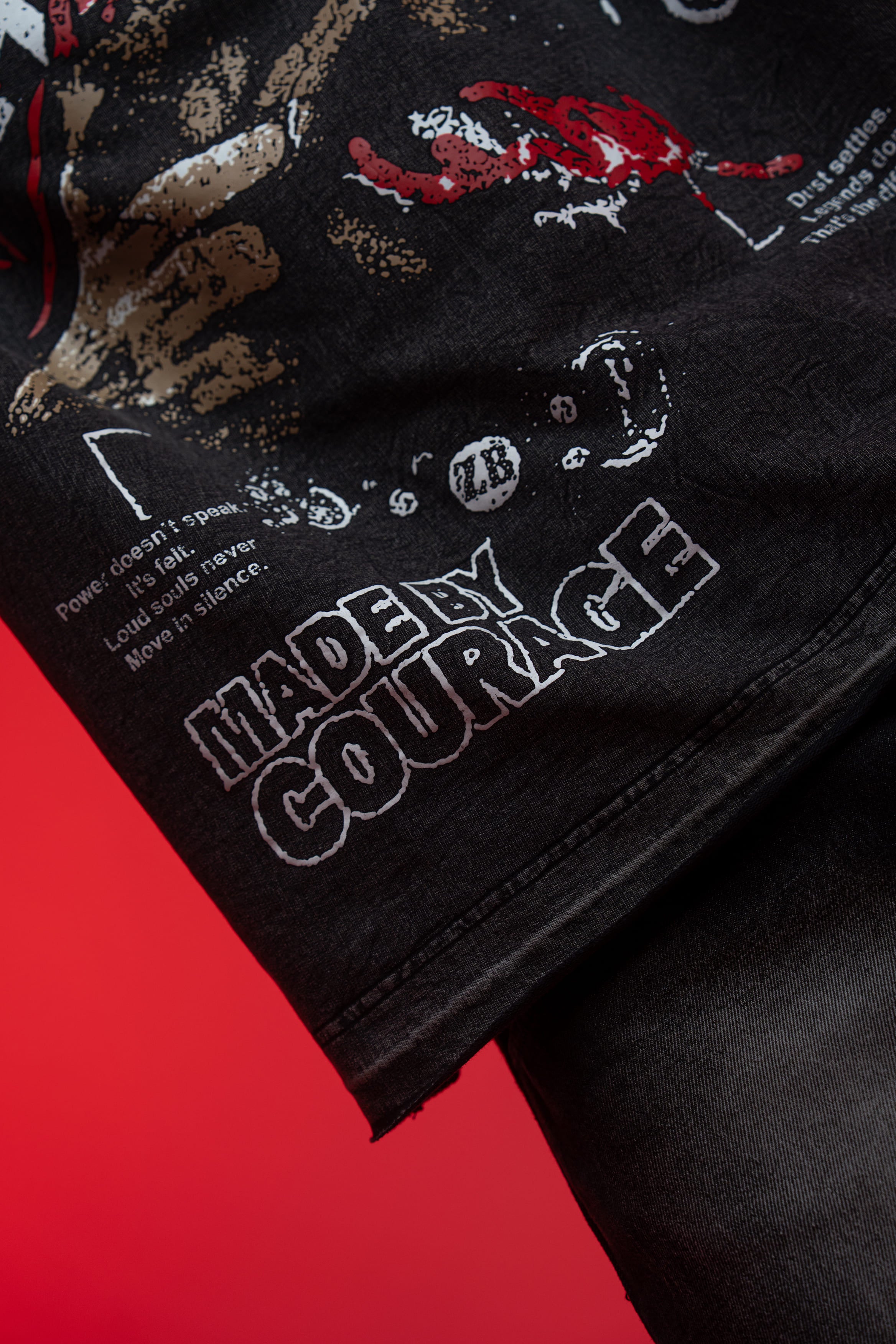 Premium screen print texture and detailed fabric close up of black acid wash t-shirt