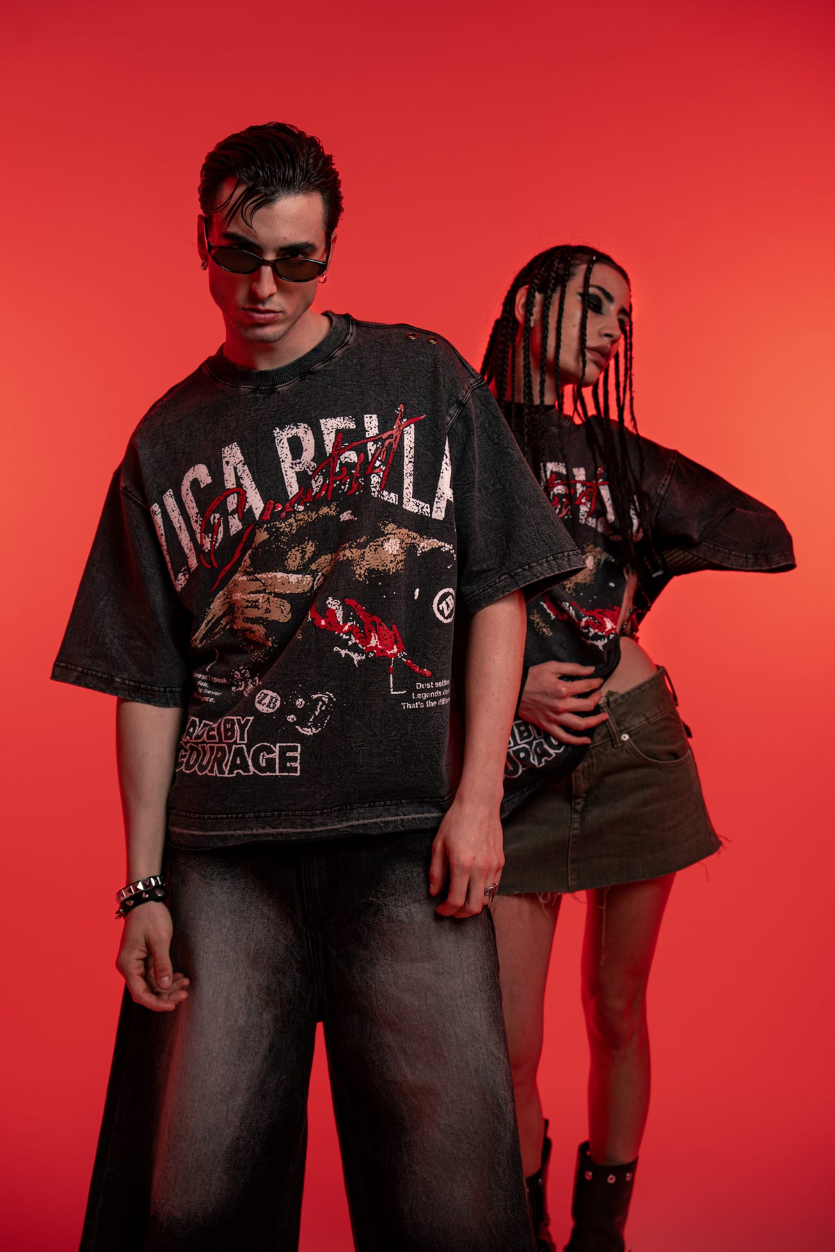 male and female models showcasing oversized acid wash graphic shirts in an urban fashion look